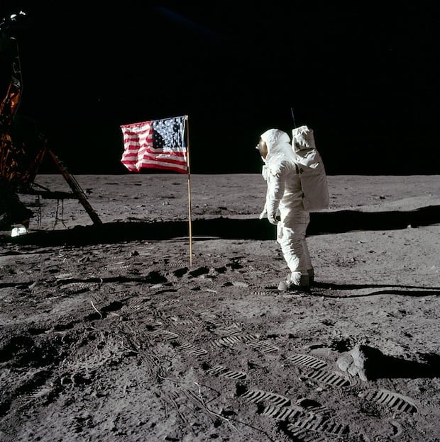 Apollo 11 astronaut Buzz Aldrin salutes the United States flag while Neil Armstrong photographs him. A moment caught on 16mm film here.