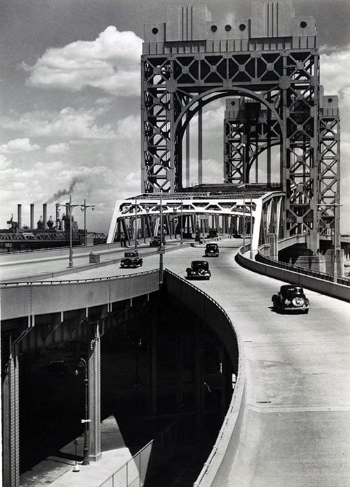 Triborough Bridge, East 125th Street approach, Manhattan. Six cars visible on approach and bridge, street below, bridge superstructure, right, smoke-stacks of Hell Gate Con-Ed. power plant, left.