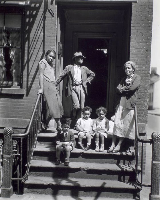 Jay Street, No. 115, Brooklyn. Three generations of African Americans on stoop of brick home with iron rails on steps.