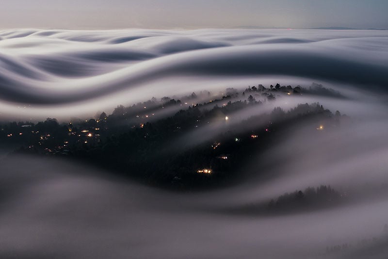 A Long Exposure of Fog Rolling Over California Under a Full Moon