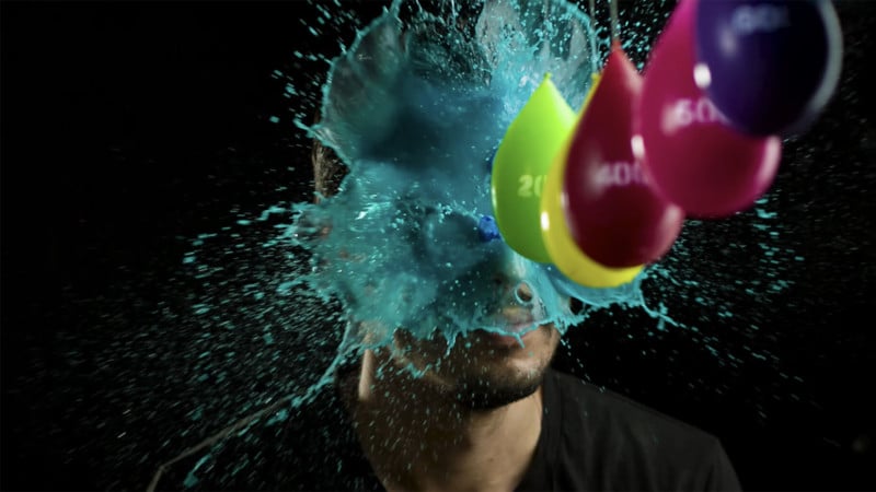 Watch Colorful Paint Smash into Artists Face in Super Slow Motion