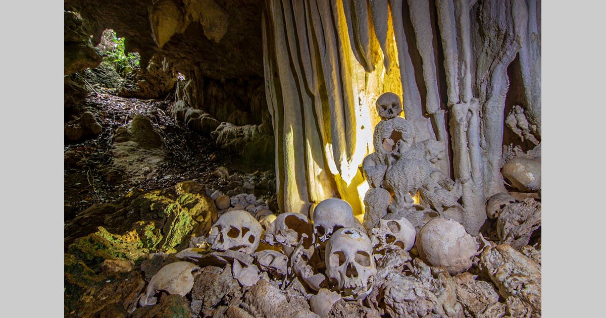  photographing cave human skulls papua guinea 