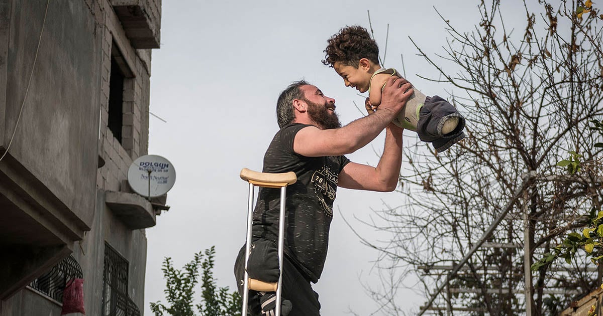 How One Photo Changed the Lives of a Refugee Father and Son