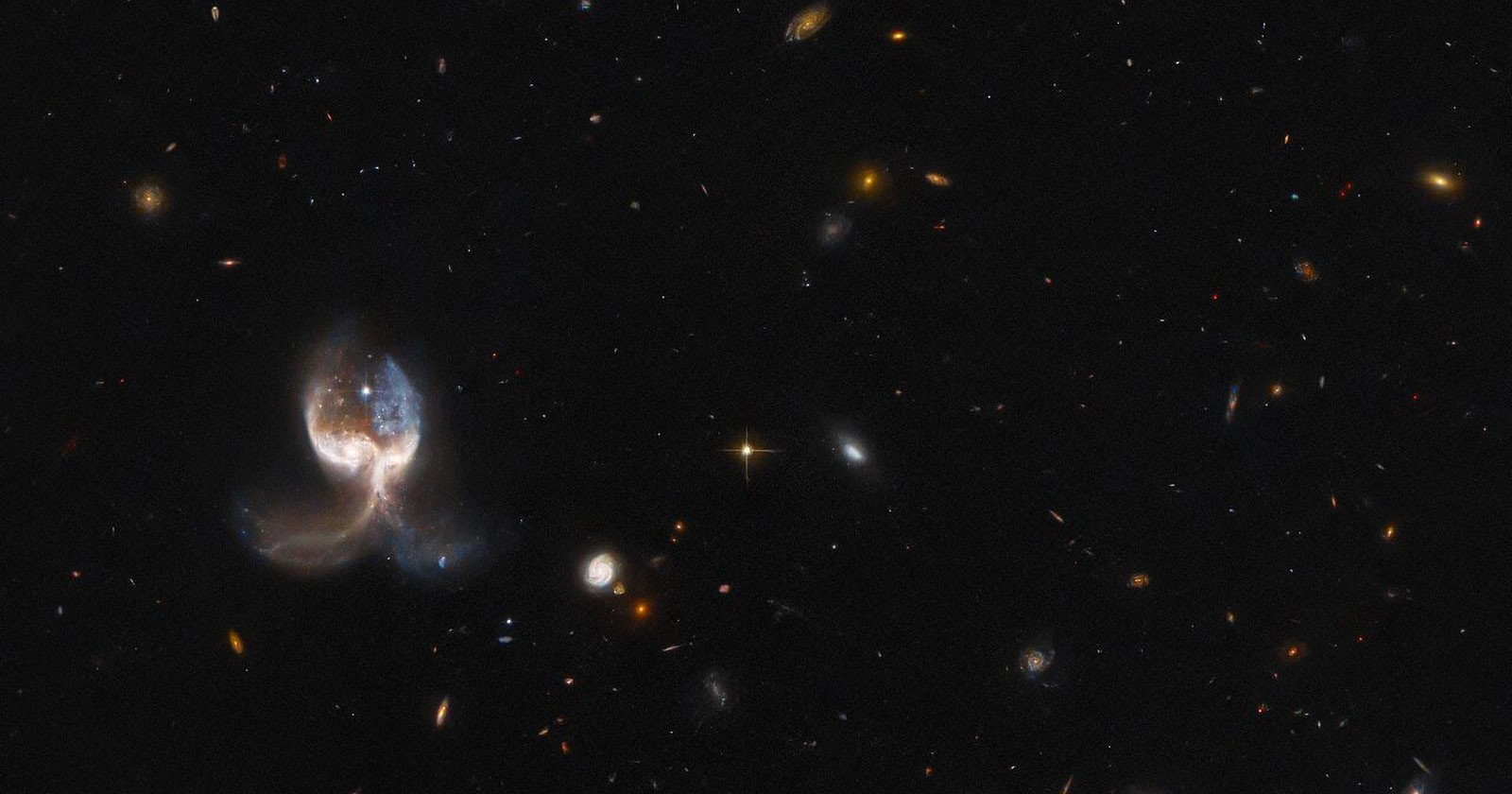 Hubbles Photo of Colliding Galaxies Looks Like a Pair of Angelic Wings
