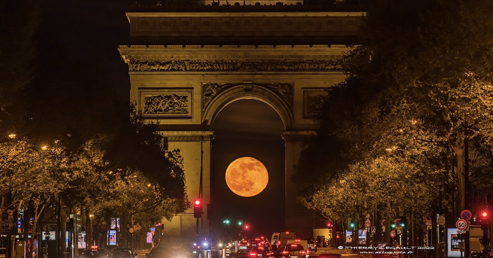  photographer captures full moon nestled under arc 