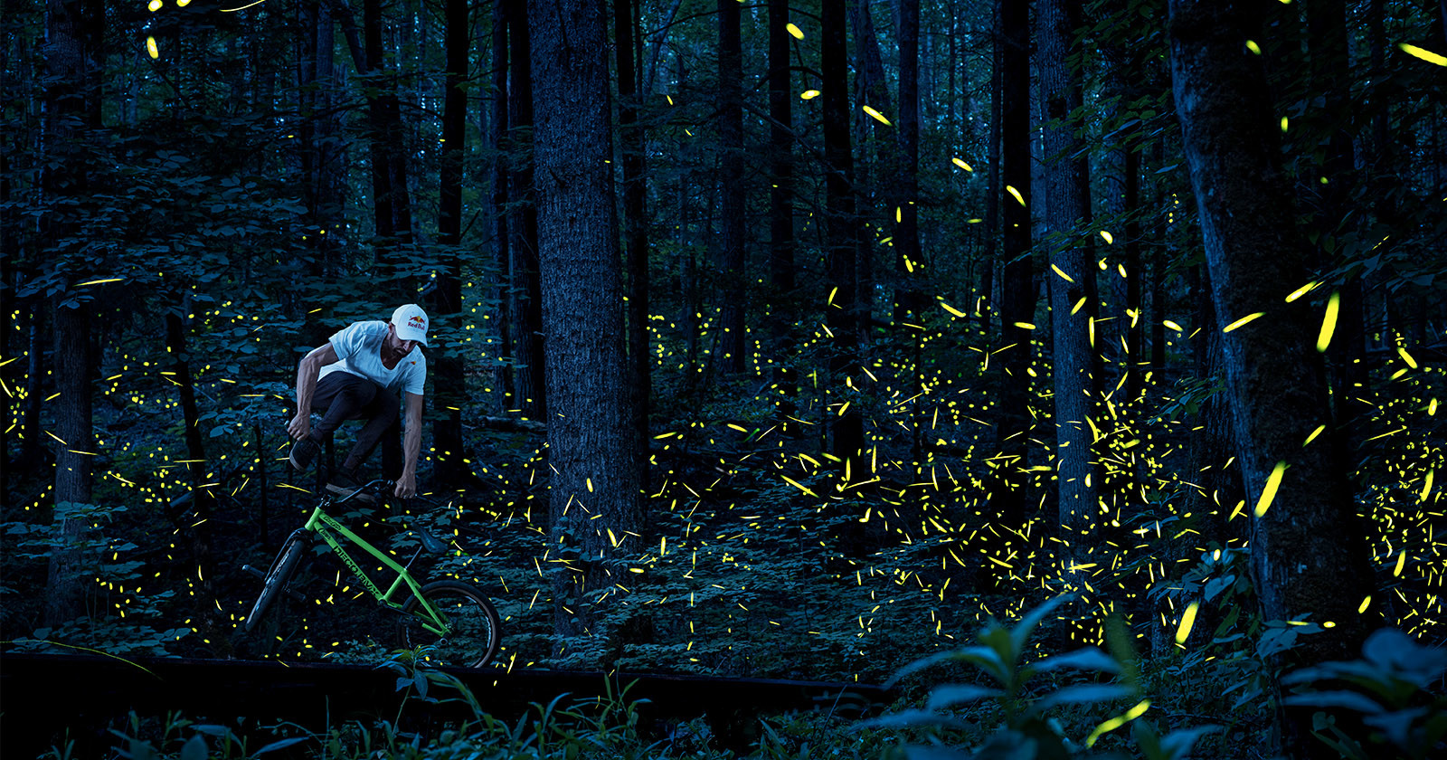  bmx biker captured among glowing clouds fireflies 