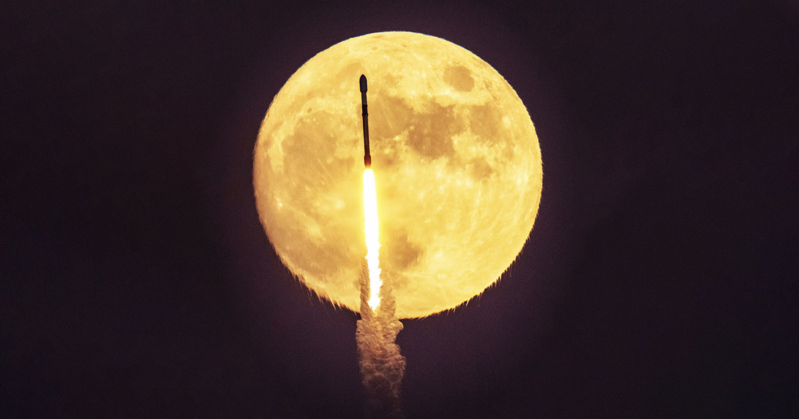  photographer captures spacex rocket firing front full moon 