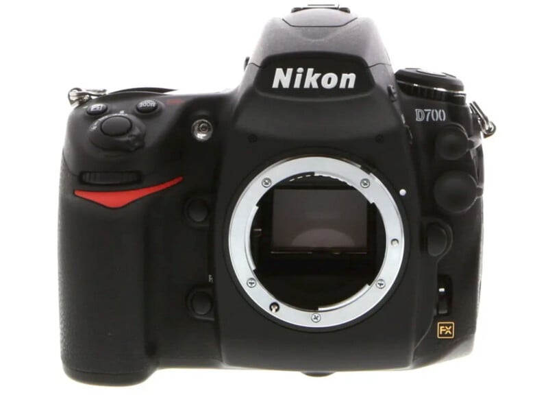 A Nikon D700 DSLR camera body is shown without a lens, displaying the camera mount and sensor. The Nikon logo and model name are clearly visible on the front.