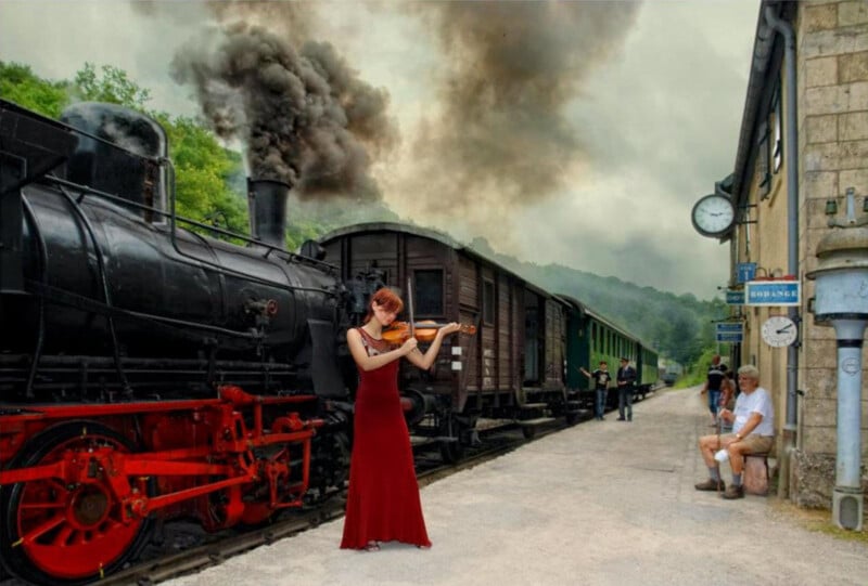 A woman in a red dress plays violin beside a black steam train at a station, with smoke billowing above. Two people sit on a bench, and others stand near the train. The scene is lively and atmospheric.