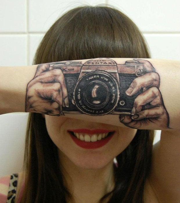 Photographer took a camera tattoo on her arm.