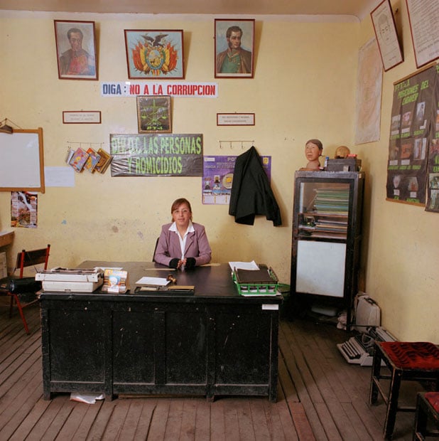 Bolivia, bureaucracy (police), 2005. Marlene Abigahit Choque (1982), detective at the the Homicide Department of the Potosi police. The department has only broken typewriters, no computer, no copy machine, not even telephone. It shares a car with the Vice Squad: "If there is no petrol in the car, we have to buy it from our own money. If the car is gone, we take the bus. We have to pay the tickets ourselves." The head on the cupboard to the right is used to make witnesses of murder cases show where the bullets went in or out.Monthly salary: 920 bolivianos (euro 102, US$ 114).