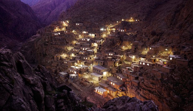 Palangan Village, in the mountains near the Iraq border. Palangan, illustrative of many of the country's rural settlements, has benefitted handsomely from government support. Many villagers are employed in a nearby fish farm, or are paid members of the  Basij, whose remit includes prevention of "westoxification", and the preservation of everything the 1979 islamic revolution and its leader the Ayatollah Khomeini stood for, including strict rules on female clothing and male/female interaction.