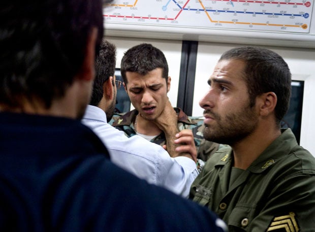 Two soldiers being attacked inside the Tehran metro after an argument. The soldier was punched in the head at least four times by an angry crowd of mostly well-dressed young men. Both soldiers were forced to leave the metro at the next sation.