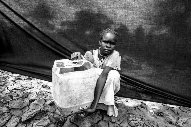 The most important thing Maria brought with her is the jerrycan (water container) that she holds in this photograph taken at Jamam camp in Maban County, South Sudan.
