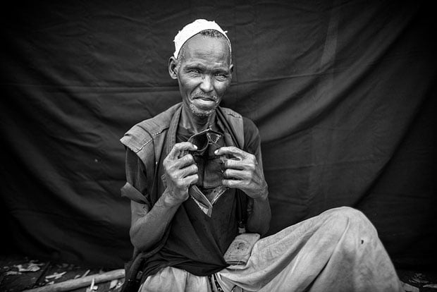 The most important object Hasan was able to bring with him is the empty wallet he holds. Though he is now destitute, he left Maganza with enough money to buy food for his family during their 25-day journey to the South Sudanese border.