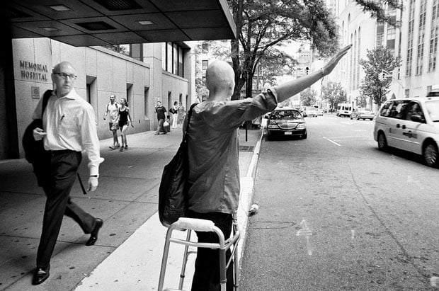 A passerby stares as Jen hails a cab.