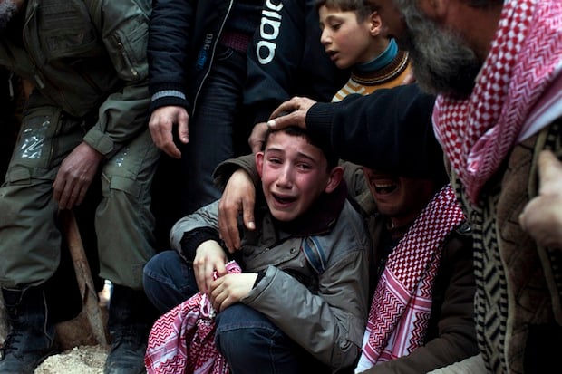 A boy name Ahmed mourns for his father, who was killed by a Syrian army sniper.