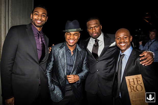 NE-YO and 50 Cent posing with CNN Heroes