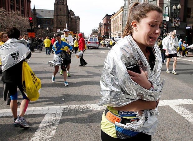 An unidentified Boston Marathon runner leaves the course crying near Copley Square in Boston Monday, April 15, 2013. Photo by AP Photo/Winslow Townson 
