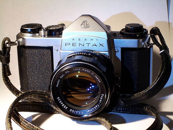 A Pentax camera with a radioactive Super Takumar 50mm f/1.4 lens attached