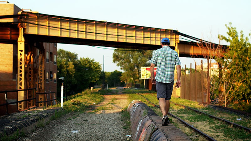 My friend Mark walks over a part of the trail above Milwaukee Avenue and below the Blue Line, an elevated train line still in service. Photo by 