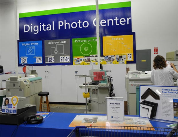 Your basic big-box store photo center. This one features a Fuji Frontier 370 Minilab (in front of worker). Photo by author.