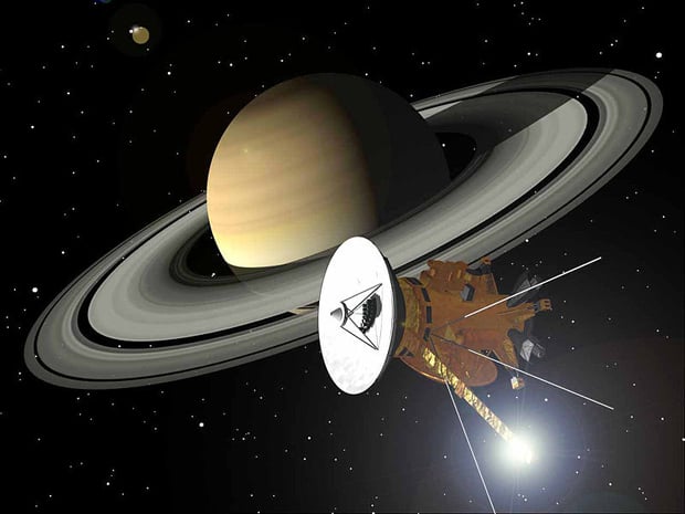 An illustration showing Cassini orbiting Saturn