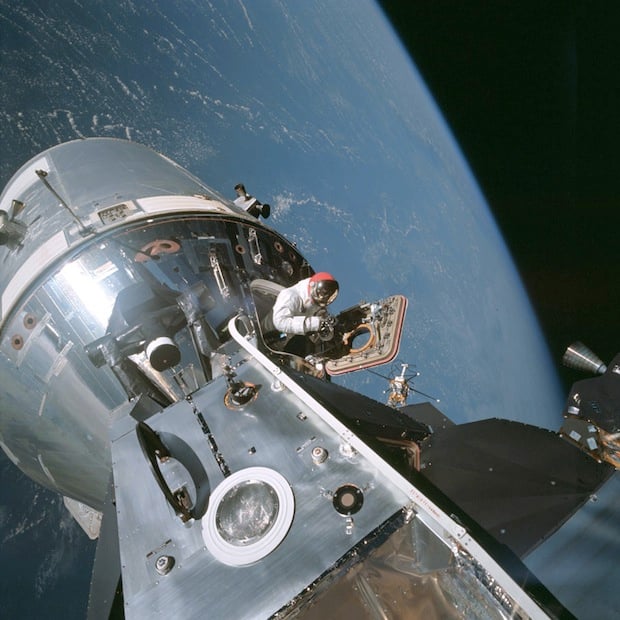 Apollo 9 astronaut Dave Scott emerging from the command module hatch.