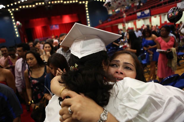 Family members embrace following the 117th commencement exercise of Yonkers Middle/High School at the Westchester County Center in White Plains. (June 20, 2013)