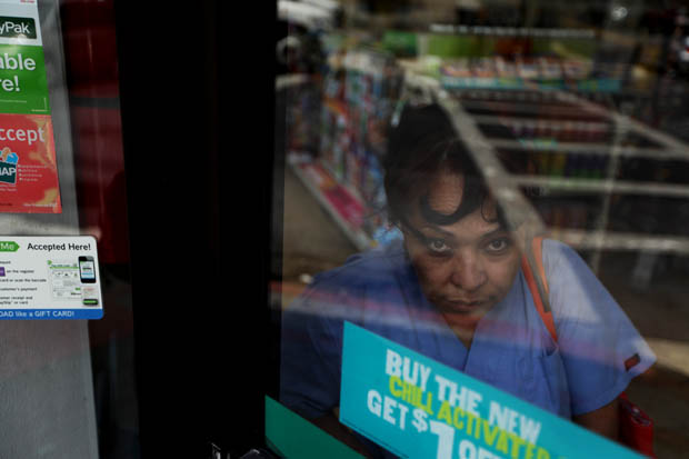 Argentina Ramirez, of Yonkers, makes a call from inside a convenience store during a day of sunny weather with temperatures in the mid-80s in Tarrytown. (June 17, 2013)