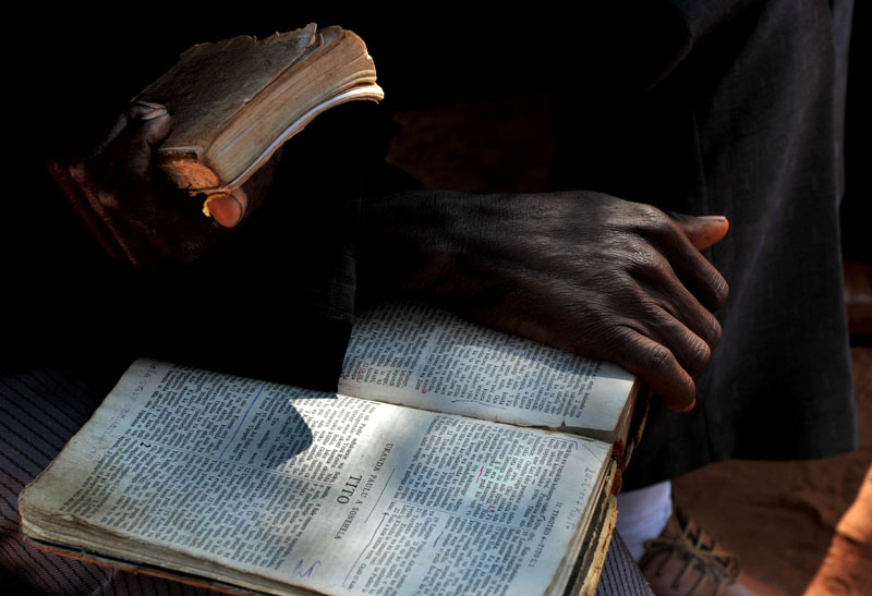A man holds his bible during church services in the village of Cassaunga