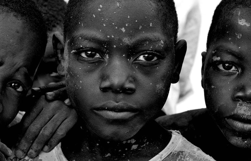 At the village of Cassaunga, mud-splattered boys pose for the camera after playing in the river.