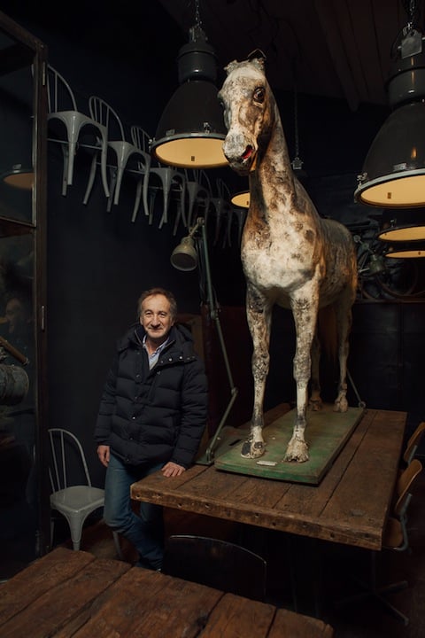 Michel is a former salesman who sells industrial furniture and "curiosities," such as the horse he is posing with.