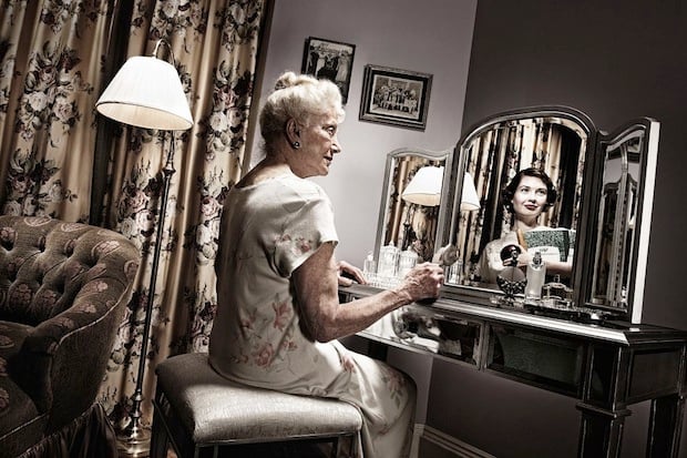 Portrait of smiling mature woman in empty room stock photo