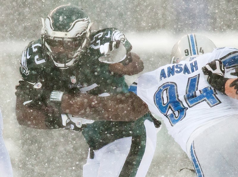 Eagles running back LeSean McCoy tries to break away from Lions defender Ezekiel Ansah (No. 94) in the second quarter of the Eagles game against the Detroit Lions on Sunday afternoon, December 8, 2013.