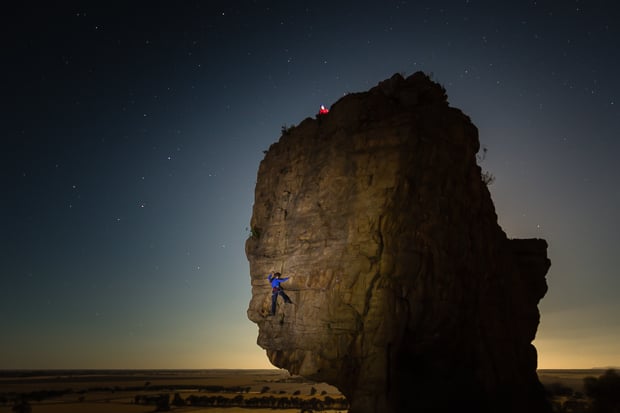 A woman is climbing a rock face, Mount Arapiles, Victoria, Australia.