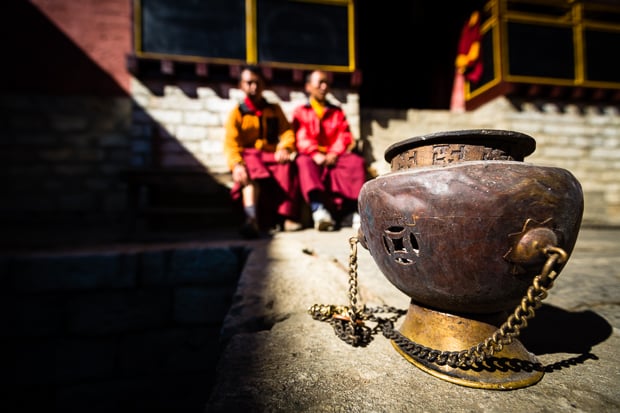 Traditional copper urn and monks, Tengboche Monastery.