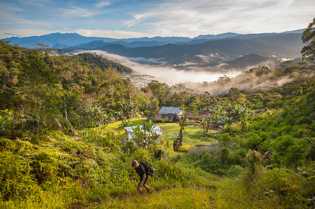 A hiker leaves Nauro village, Kokoda Trail.