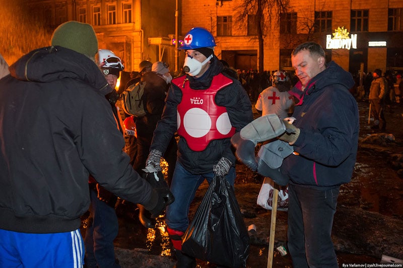 Volunteer giving out dry, waterproof boots at the front line.