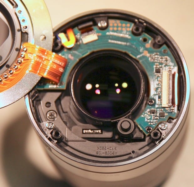 Sony 50mm f/1.8. The 4 hollow plastic posts are where the screws from the lens mount attach.