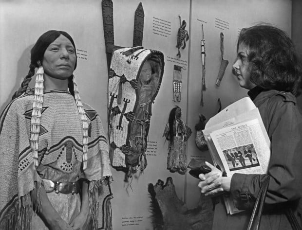 Visitor viewing display of clothing and artifacts, Hall of Plains Indians, 1967