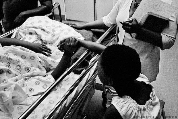 A girl supports her friend, who was allegedly raped with another girl during a school outing. Johannesburg General Hospital. November 2002