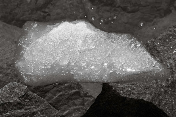 A small piece of ice floats in Iceberg Lake in August.