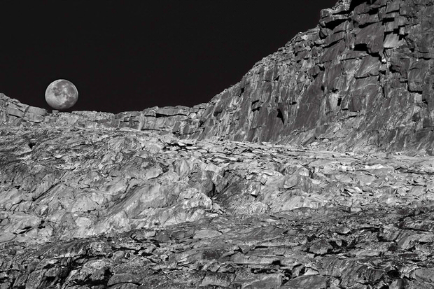 A waning moon sets over the granite cliffs near Donahue Pass.