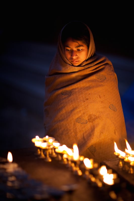 A young girl selling butterlamps in Kathmandu, Nepal
