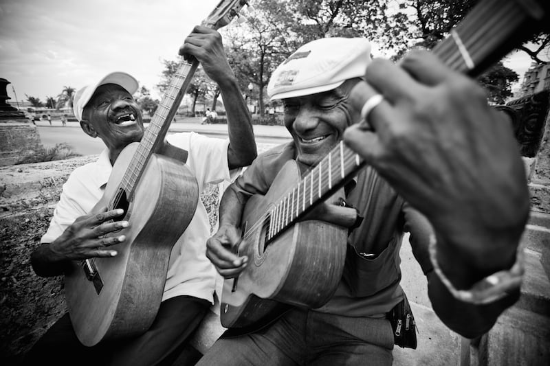 Two men play guitar in Old Havana, Cuba.