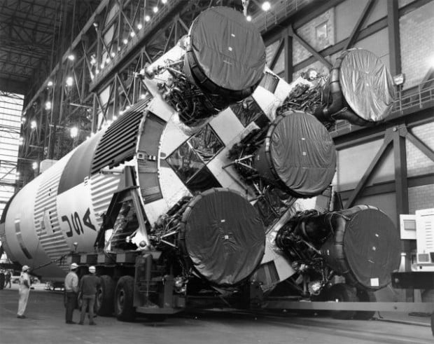 Workers make preparations to the S-IC first stage rocket in the the Vehicle Assembly Building.