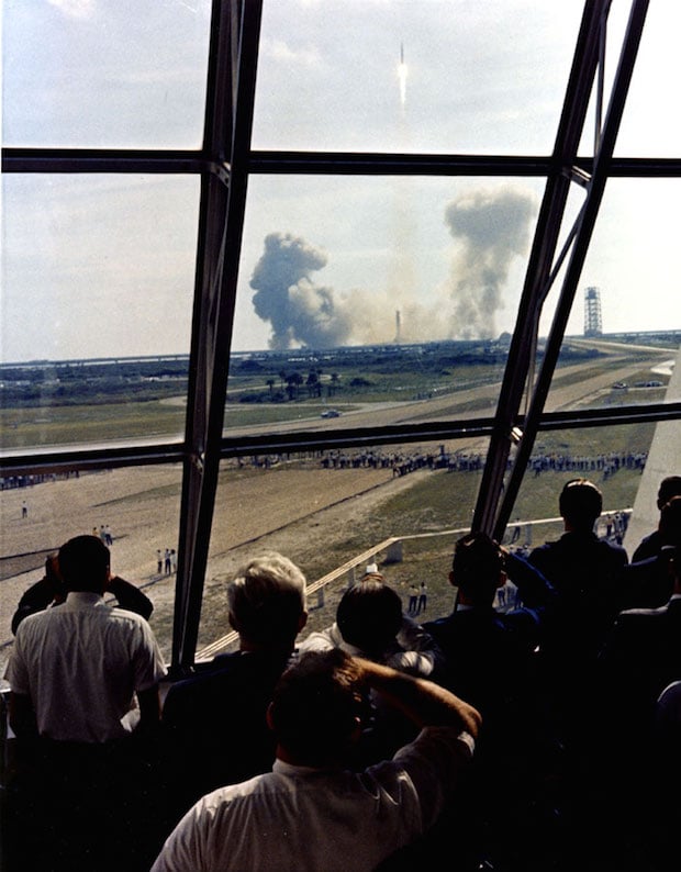 Launch team members view the Apollo 11 through the firing room windows.