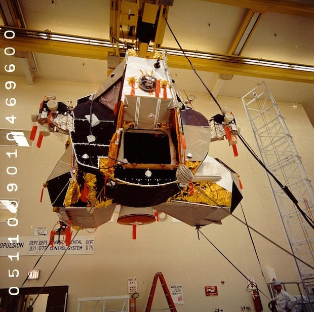 Lunar Module 5 is held in place via an overhead hoist before inspection.