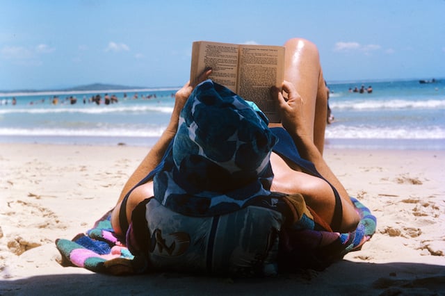 This is my Grandma, June Clarke on the beach. Probably in Brisbane, Australia.  I can't work out what she's reading. Such a great shot, typical of Australian life in Summer.